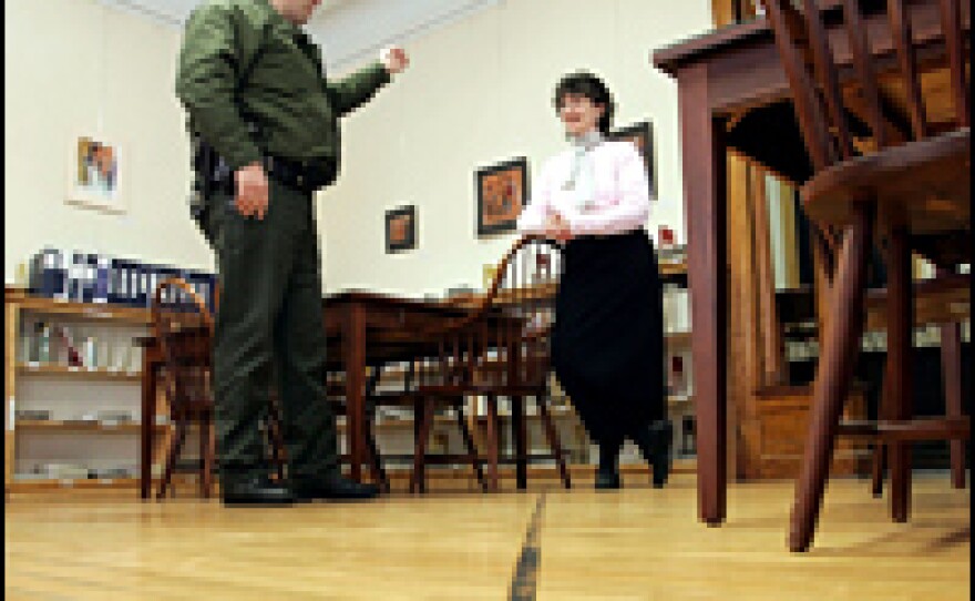 A Border Patrol agent speaks to Nancy Rumery in the Haskell Free Library and Opera House that marks the U.S.-Canada border in Derby Line, Vt., in this 2006 photo.