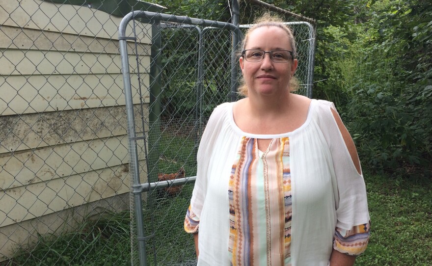 Medical debts weigh on Geneva Wilson, who keeps a chicken and rooster in a coop behind her cabin in rural southwest Missouri.