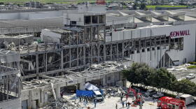 In this aerial image taken with a drone, responders work outside AEON Mall Kumamoto after an explosion occurred following an earthquake, in Kashima, Kumamoto Prefecture, southern Japan, Thursday, July 30, 2026.