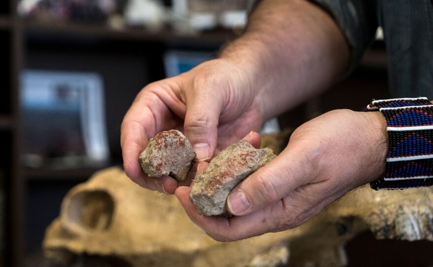 Red rock found on the site. There is evidence that the rock was drilled to extract its red pigment.