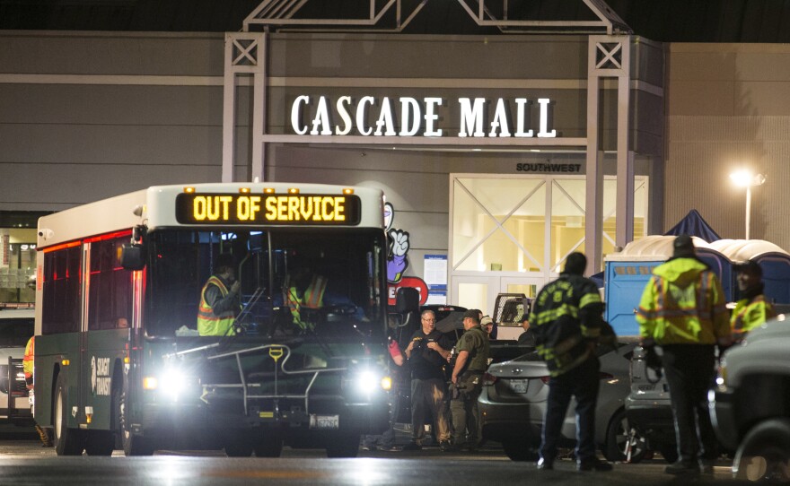 Emergency personnel gather at an entrance to the Cascade Mall in Burlington, Wash., after five people were killed there on Sept. 23, 2016.