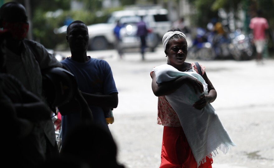 A woman and her baby at Immaculée Conception Hospital, which is still receiving people injured in the earthquake.