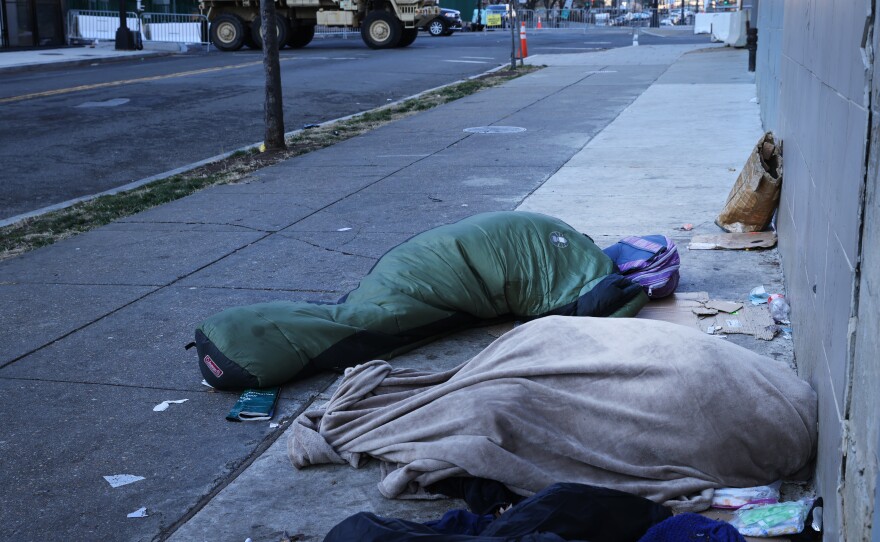 Homeless individuals sleep near a National Guard truck ahead of the inauguration of U.S. President-elect Joe Biden on Jan. 20, 2021, in Washington, D.C.