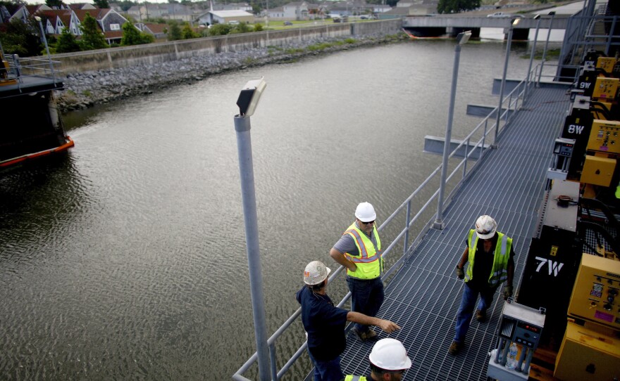 Engineers and maintenance crews stand on a temporary steel structure that holds the generators for the giant pumps at the 17th Street Outfall Canal, which is part of the Orleans Levee District in New Orleans.