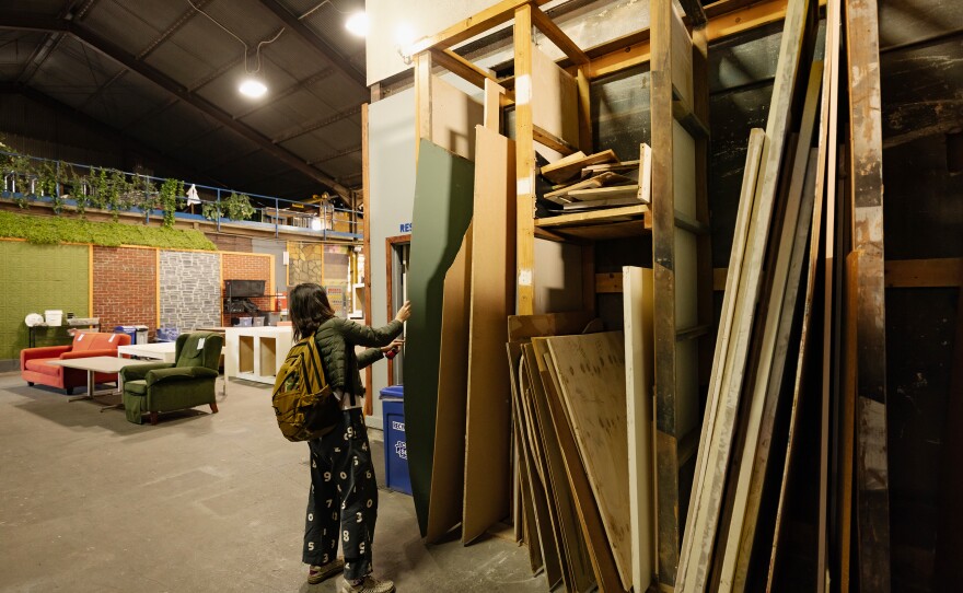 Liao shops for materials in EcoSet's aisles. When sets get too old to rent out to big-budget productions, they often wind up at places like the Los Angeles-based company.