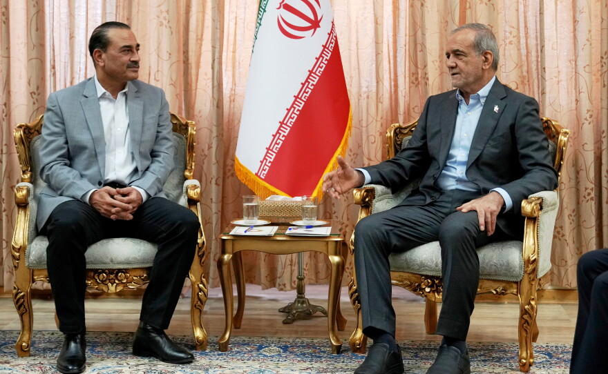 In this photo released by the Iranian Presidency Office, President Masoud Pezeshkian, right, speaks with Pakistan's Army Chief Field Marshal Gen. Asim Munir in Tehran, Iran, Saturday, May 23, 2026.