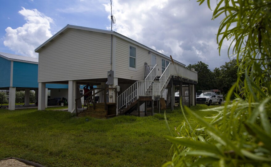 Amy Tripp's home sits on a platform to avoiding flooding damage, but its flood insurance rate will still go up.