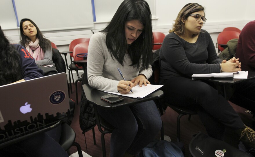 Daisy Romero takes notes in class.