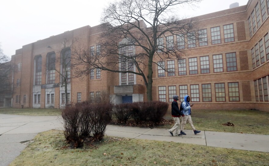Students walk outside Detroit's Pershing High School in 2017. A lawsuit claims the state of Michigan failed to provide the city's students with the most fundamental of skills: the ability to read.