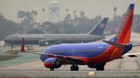 United Airlines and Southwest Airlines jets taxi at Los Angeles International Airport on December 21, 2009.
