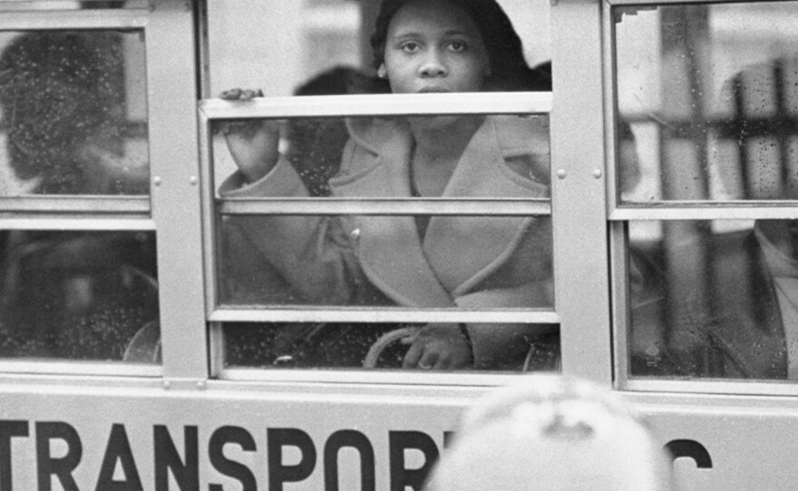 White students boycott classes at South Boston High black student looks out the window of bus. 