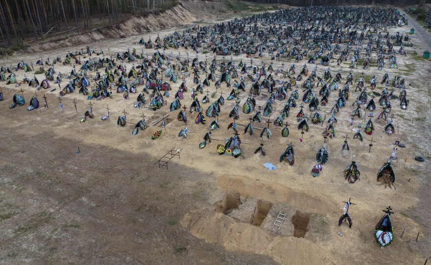 <strong>April 19:</strong> Three dug graves are ready for the next funerals at the cemetery in Irpin, a suburb of Kyiv.