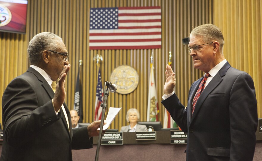 Former San Diego County Treasurer-Tax Collector Dan McAllister (right) gets sworn in at the County Administration building, Jan. 5, 2015. 