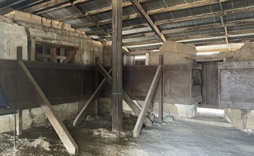 The Trujillo Adobe's three remaining walls are held up by supports to prevent further damage.
