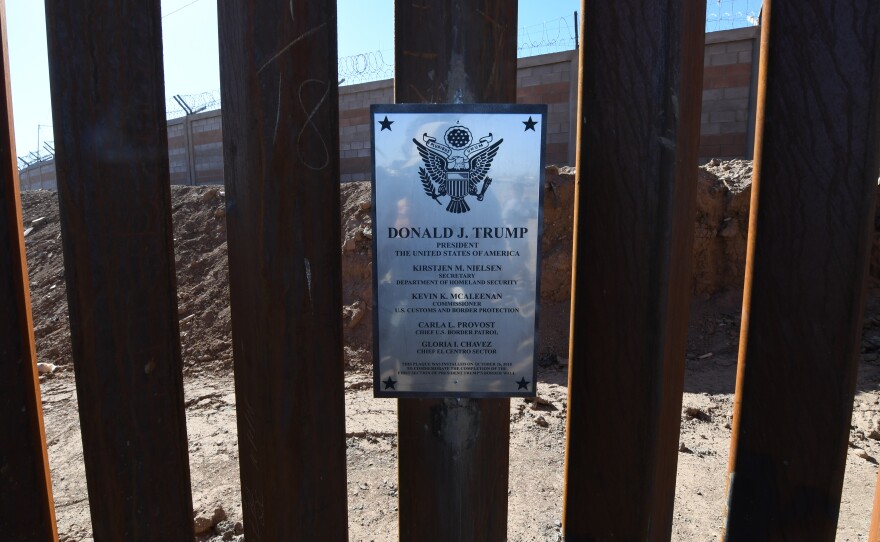A plaque placed by Nielsen is seen on the border wall.