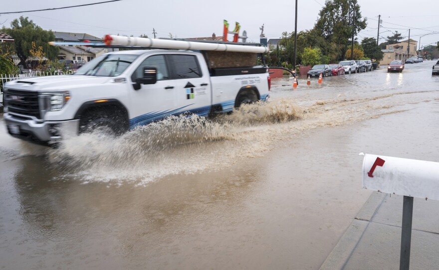 A truck is driven through a flooded intersection of Salinas, Calif., on Tuesday. The first in a week of storms brought gusty winds, rain and snow to California on Tuesday, starting in the north and spreading southward.