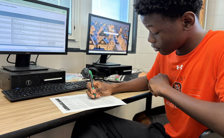 Sophomore Damola Kukoyi fills out a worksheet in his AP Business with Personal Finance class at Hoover High School on October 6, 2026.