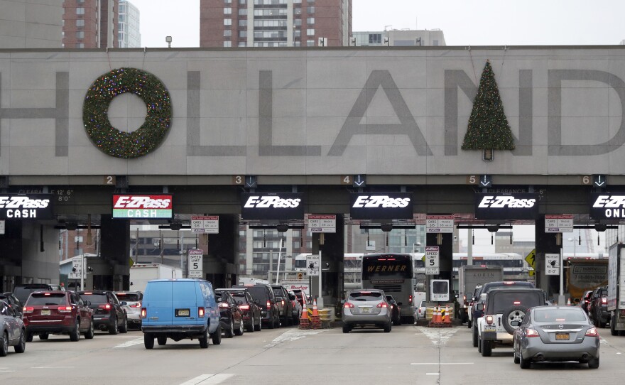 Holiday decorations adorn the letters on the toll booths at the Holland Tunnel last week in Jersey City.