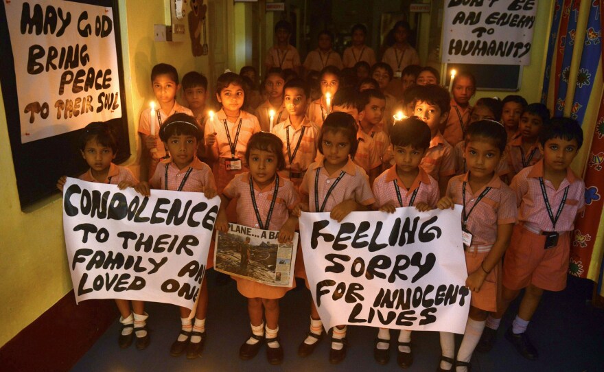 Indian schoolchildren hold candles and prayer messages for those killed in the crash of a Malaysia Airlines plane carrying 298 people from Amsterdam to Kuala Lumpur.