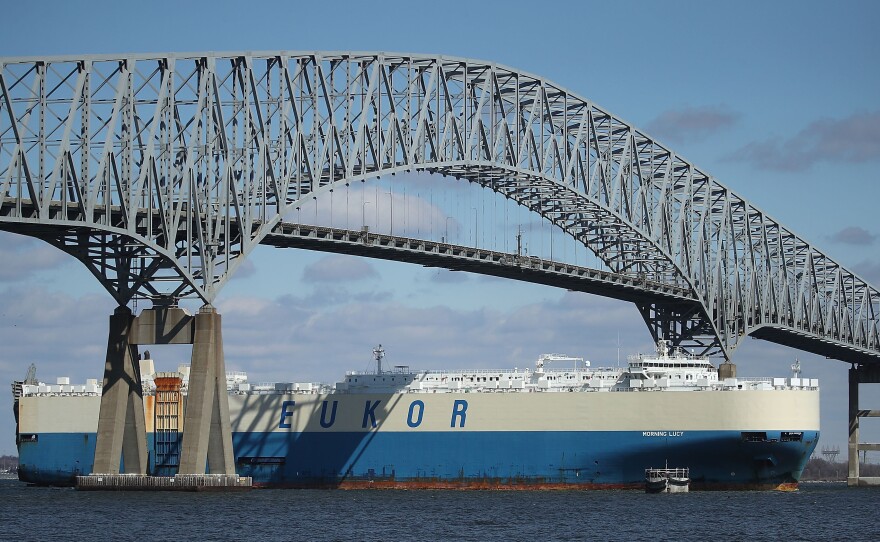 An outbound cargo ship passes under the Francis Scott Key Bridge in Baltimore in 2018. A cargo vessel slammed into the steel-truss bridge on March 26 of this year, causing it to collapse.
