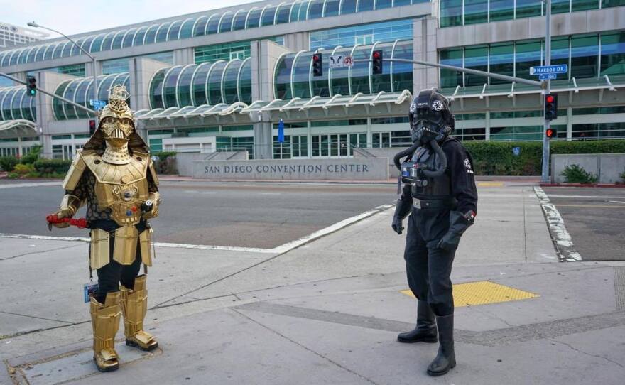 Dude Vader (Christopher Canole) and a TIE Fighter pilot (Todd Felton) welcomed people to the empty San Diego Convention Center on Wednesday. Comic-Con would have started that day if the coronavirus had not forced the pop culture convention to move online.