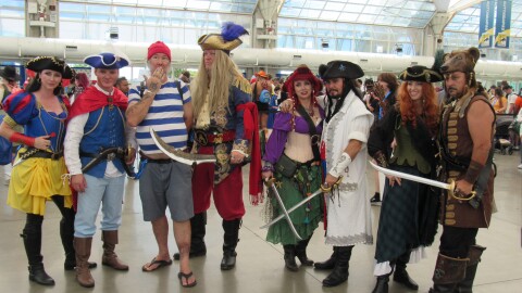 Comic-Con attendees dressed as Disney-inspired pirates pose in Sail Pavilion at the San Diego Convention Center on Ju