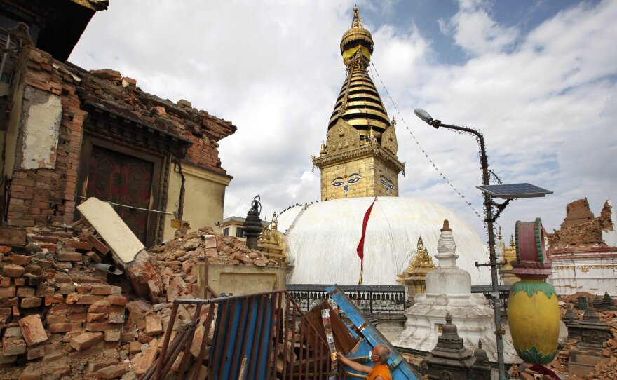 A Buddhist monk picks through a damaged monastery near the Swayambhunath stupa.