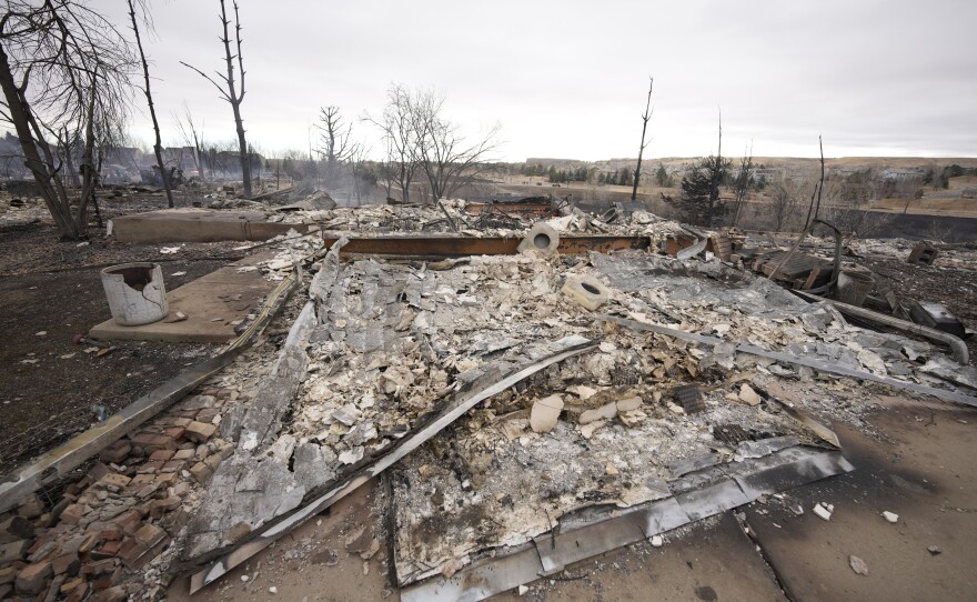 Dec, 31: Superior, Co. — Debris surrounds the remains of homes burned by wildfires after they ripped through a development.