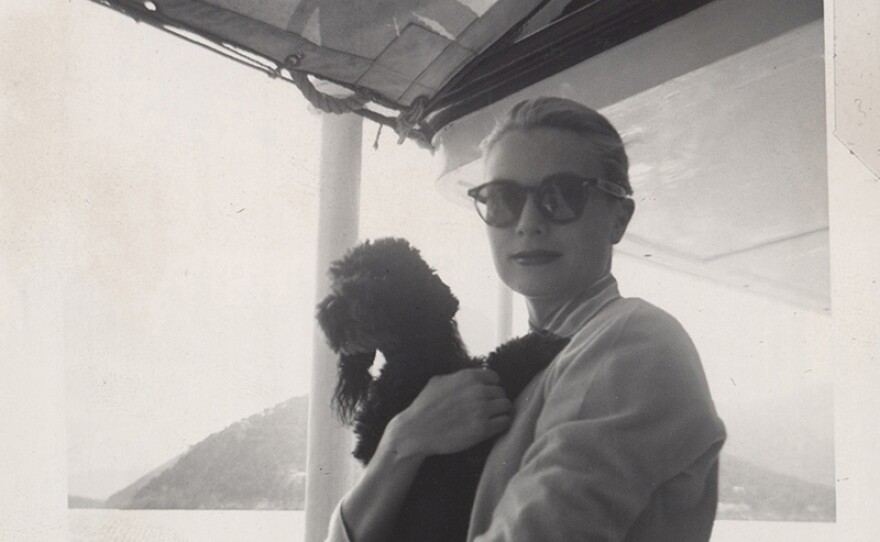Grace Kelly holding a dog. (undated photo)