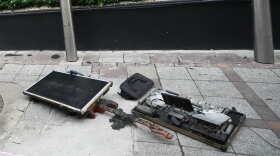 Burned musical instruments sit in front of a music bar fire in Bangkok, Thailand, Monday, July 13, 2026.