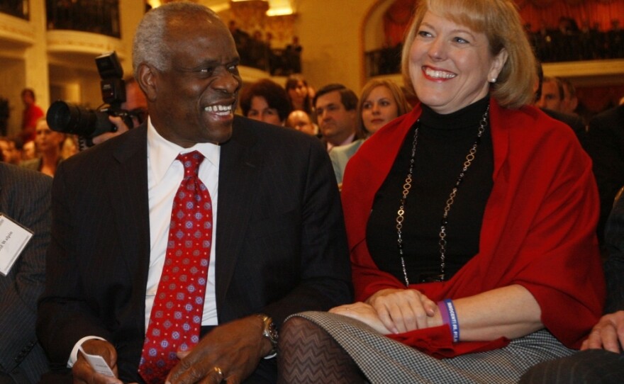 Supreme Court Justice Clarence Thomas sits with his wife, Virginia Lamp Thomas, as he is introduced at the Federalist Society in Washington, D.C., on Nov. 15, 2007.