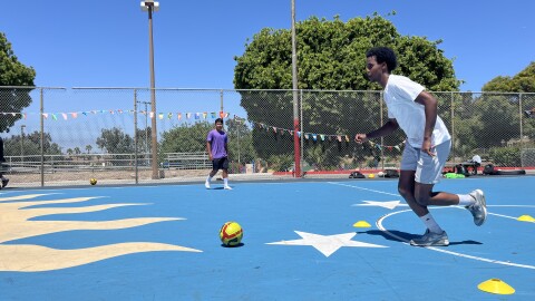 Khalid Hassan dribbles a soccer ball at Colina Del Sol Park's basketball courts, July 10, 2025.
