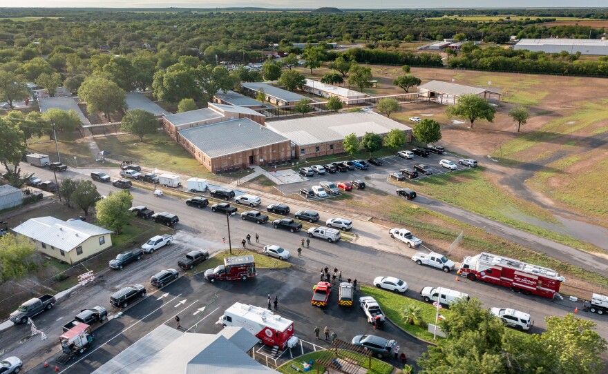 In this aerial view, law enforcement works on scene after at shooting Robb Elementary School in Uvalde, Texas.