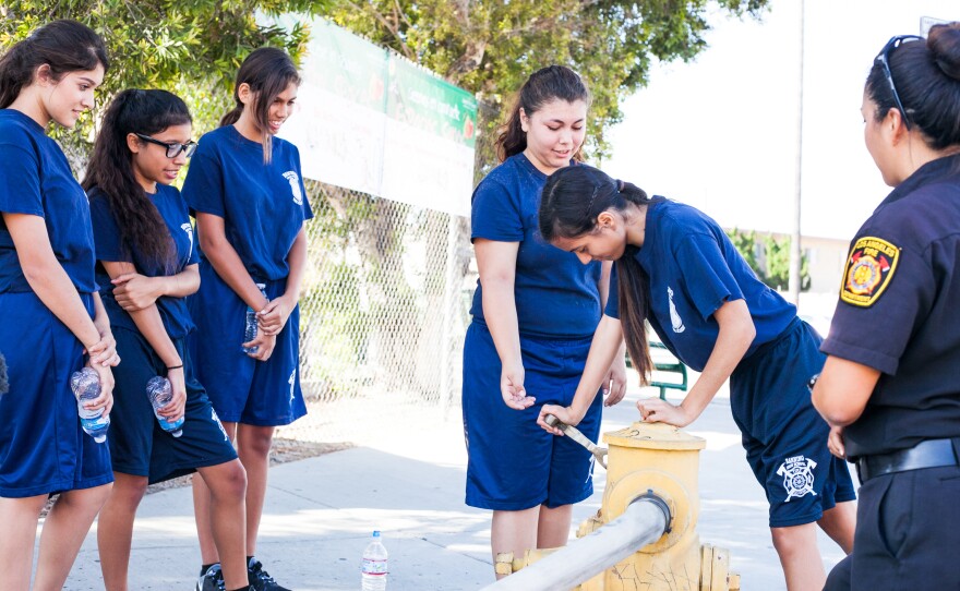 Gail Sonoda (right), an instructor and firefighter with the Los Angeles Fire Department, teaches young cadets how to work a hydrant.
