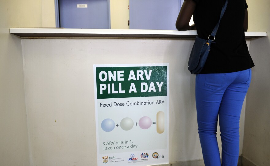 A woman waits to get AIDS drugs on April 8 at a clinic in Ga-Rankuwa, South Africa, about 55 miles north of Johannesburg. New WHO guidelines say patients should start HIV treatment much earlier, before they become extremely sick.