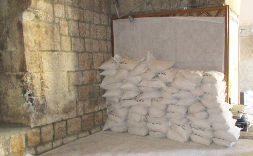 Sandbags are stacked on the inside walls of the Ma'arra museum, shielding fragile, ancient mosaics from the blast of regime jets and looters.