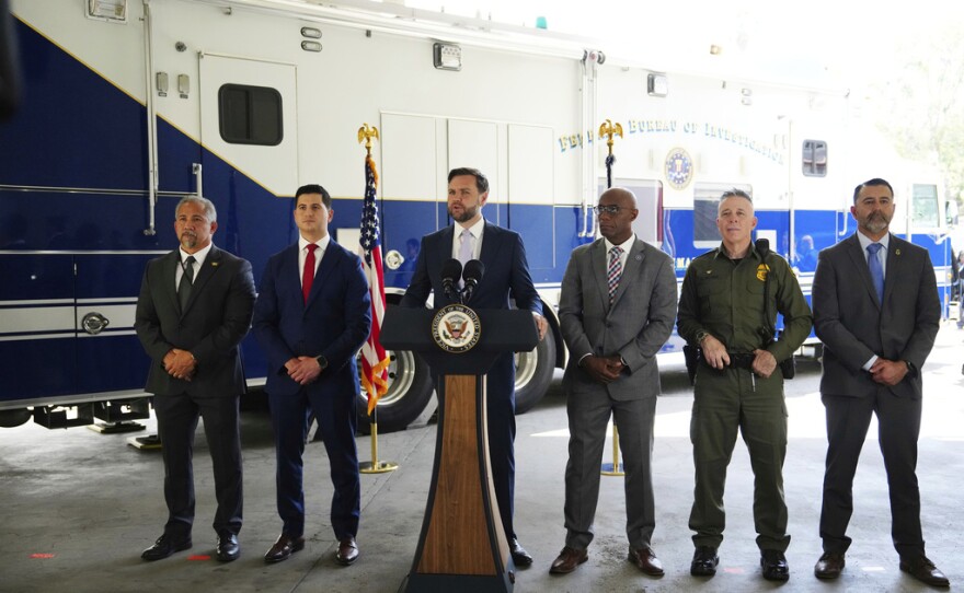 Vice President JD Vance, center, speaks next to officials including, from left to right, HUD Regional Administrator William Spencer, United States Attorney for the Central District of California Bill Essayli, FBI Los Angeles Assistant Director Akil Davis, US Border Patrol Sector Chief Gregory Bovino and ICE Field Office Director Ernie Santacruz at the Wilshire Federal Building Friday, June 20, 2025, in Los Angeles.