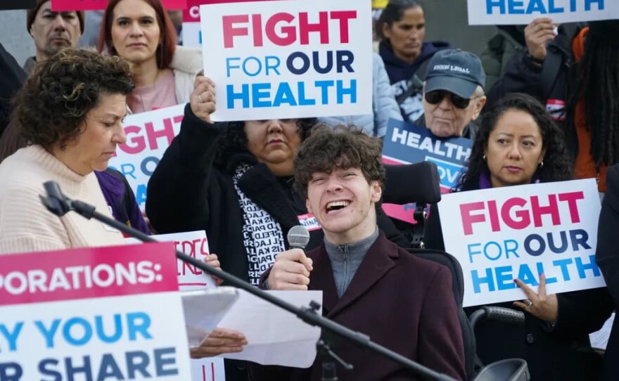 Max Zonana speaks to the crowd during a Fight for Our Health Coalition rally about how Medicaid helps him live independently at the state Capitol on Jan. 14, 2026.