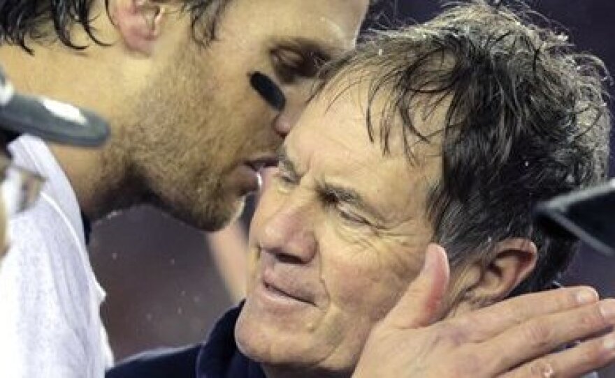 New England Patriots quarterback Tom Brady, left, speaks with Coach Bill Belichick, after the NFL football AFC Championship game Sunday, Jan. 18, 2015, in Foxborough, Mass.