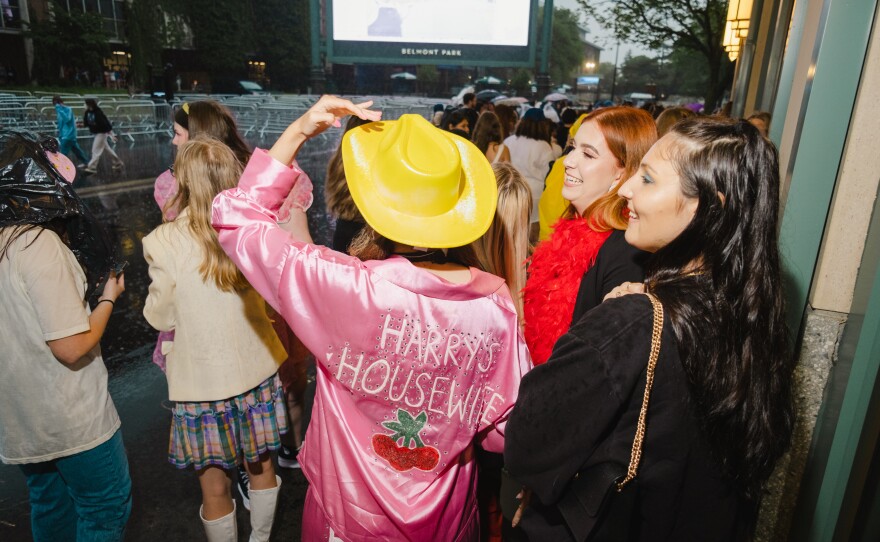 Fans showing their love for Harry Styles with customized pants and tops with the pop star's name.