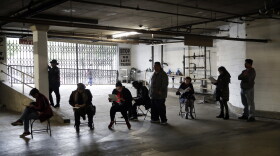 Hospitality workers wait in line to apply for unemployment benefits at the outset of the COVID-19 pandemic in March 2020.