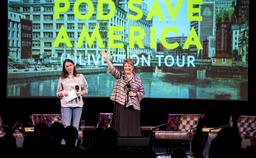 Judge Janet Protasiewicz, center, waves to the audience during a <em>Pod Save America</em> live podcast event Saturday, March 18, 2023, at the Barrymore Theatre in Madison, Wis.