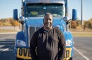 Heavy haul trucker Eric Jammer stands in front of his truck.