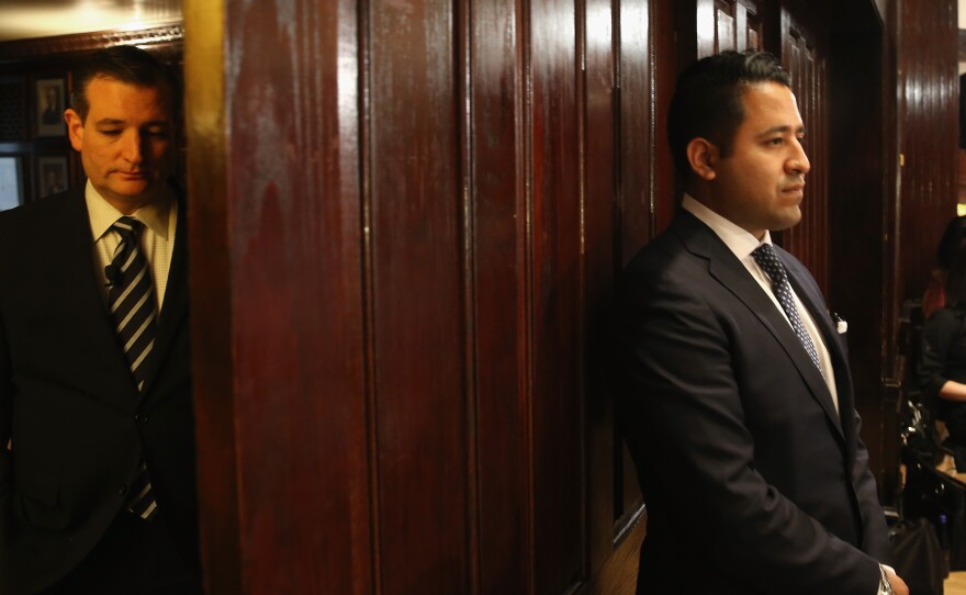 Cruz (left) waits off stage as he is introduced to speak to the Hispanic Chamber of Commerce.