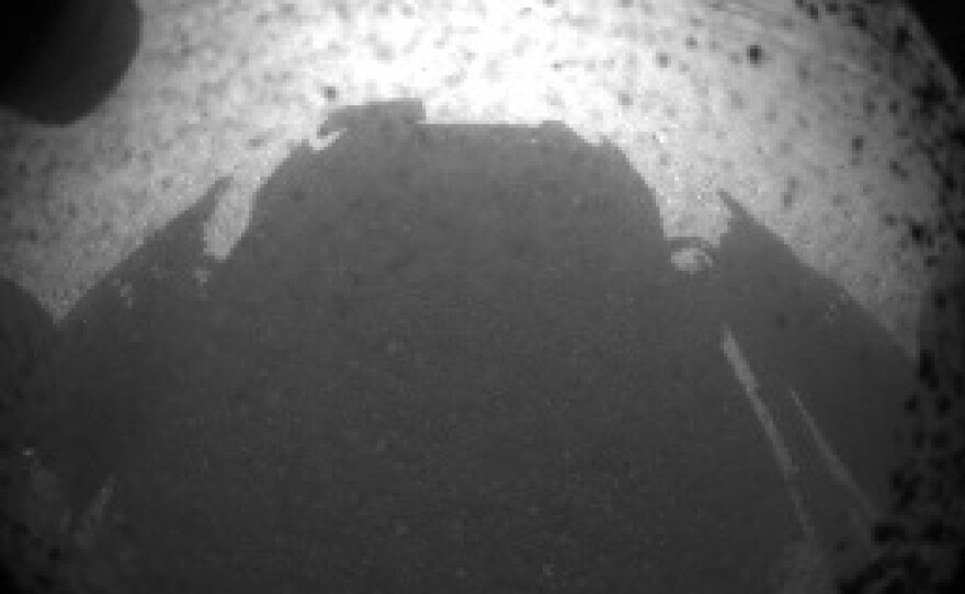 Curiosity's shadow on the surface of Mars, just minutes after the rover landed on the surface of the planet.