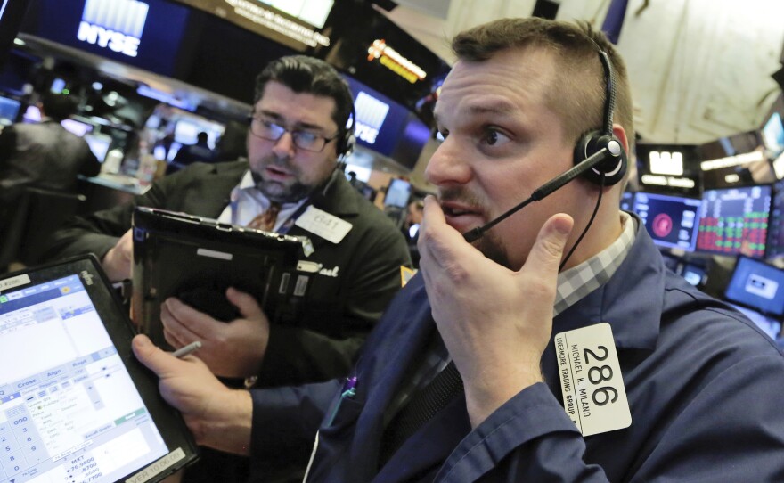 Trader Michael Milano (right) on the floor of the New York Stock Exchange on Thursday, a day when all the major U.S. stock indexes saw sharp drops.
