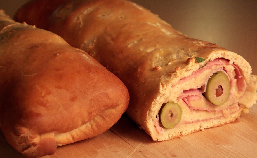 Pan de jamon is a traditional Venezuelan Christmas bread. It's savory, not sweet, made with a mildly garlicky dough and filled with ham, bacon, green olives — and raisins.