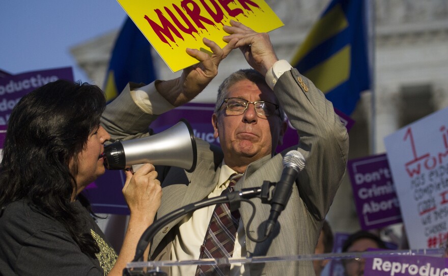 Operation Rescue founder Randall Terry is confronted by a supporter of abortion rights in front of the Supreme Court on Monday as President Trump announced his nomination or Brett Kavanaugh to the Supreme Court. Abortion will be a key issue in the confirmation process.