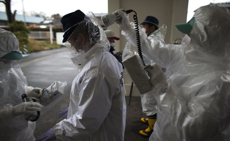 Japanese policemen wearing a protective suits undergo testing for possible nuclear radiation at screening center about 35 kilometers away from Fukushima Nuclear Power Plant as they finish their duty inside exclusion zone on April 9, 2011 in Minamisoma, Fukushima Prefecture, Japan. 