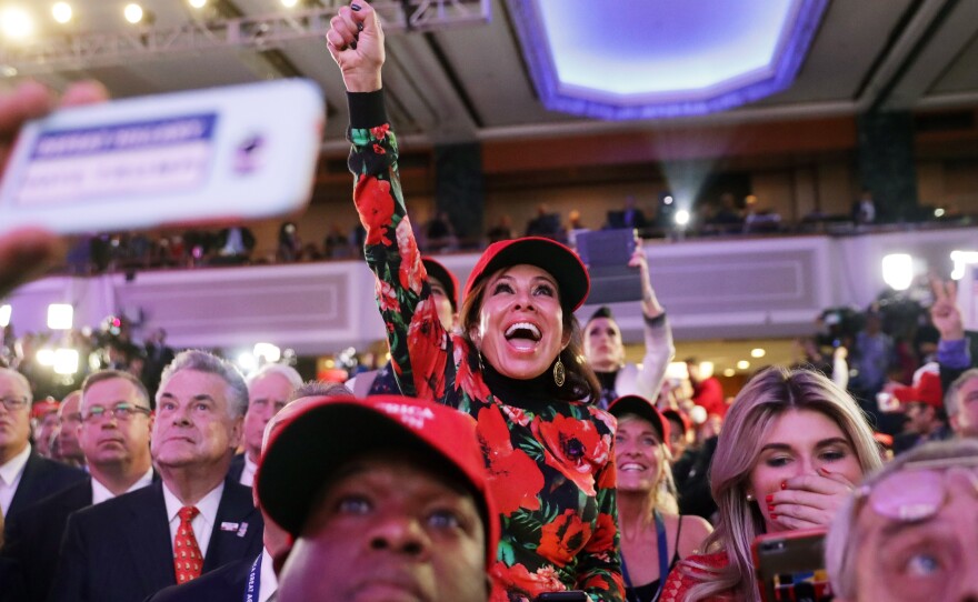Donald Trump supporters cheer on Tuesday night at the New York Hilton Midtown.